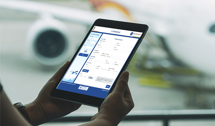 A traveller using a tablet to fill out India’s new e-Arrival Card form online before boarding a flight at the airport.
